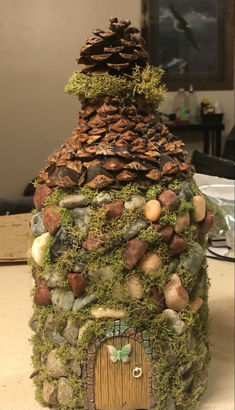 Juice bottle turned into fairy house with hot glue , rocks , moss , pine cones and store bought door Plastic Bottle Fairy House, Recycled Fairy House, Milk Jug Fairy House, Starbucks Bottle Crafts, Faery Magick, Castle Crafts, Jar Projects, Diy Water Bottle, Bottle House