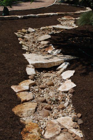 One family's xeric project - "We" dug an 80' dry creek bed which has three "bridges" across it. (Sula Howell) Dry Creek Bed Bridge, River Backyard, Dry Riverbed Landscaping, Dry Stream, Stone Bridges, Dry Creek Bed, Dry River, River Rock Landscaping, Pond Landscaping