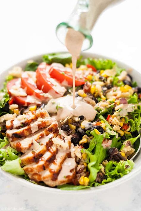 This Copycat Panera Bread BBQ Chicken Salad recipe is a delicious lunch or dinner. Chopped lettuce, tender grilled chicken, roasted corn salsa, tomatoes and crispy french fried onions round out this salad with tangy BBQ sauce and BBQ Ranch dressing drizzled over the top. It's as healthy as it is tasty and so quick and easy that it practically begs you to make it for a simple weeknight dinner! Copycat Panera Bread, Bbq Chicken Salad Recipe, Bbq Ranch Dressing, Panera Salad, Panera Recipes, Bbq Salad, Copycat Panera, Grilled Chicken Tenders, Bbq Salads