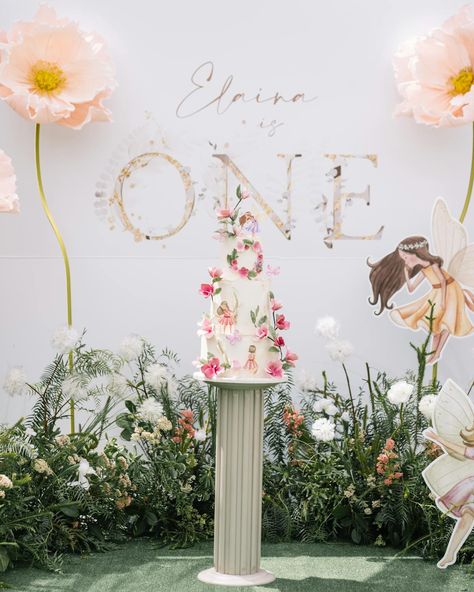 Elaina's Fairy 1st Birthday | Event Du Jour | PartySlate Diy Fairy Backdrop, Fairy 1st Birthday Backdrop, Thumbelina Birthday Party, Fairy Photo Backdrop, Fairy Birthday Backdrop Ideas, Birthday Flowers Decorations, Fairy First Birthday Party Backdrop, Fairy Backdrop Birthday, Fairytale First Birthday Party