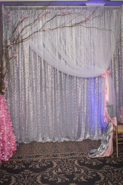 A stunning all sequin Silver Backdrop with the softness of white sheer organza and curly willow accenting the look. By True elegance Design & Decorating. White And Silver Photo Backdrop, Wedding Anniversary Backdrop, ขวดโหล Mason Jar, Anniversary Backdrop, Closet Curtain, Silver Backdrop, Sequin Backdrop, Curly Willow, Curtain Backdrops