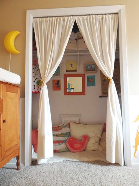 i love the curtains and the children's artwork on the wall :) Kids Closets Used as Reading Nooks Closet Nook, Reading Nook Closet, Reading Nook Kids, Zimmer Diy, Kids Closet, Reading Nooks, Kid Closet, غرفة ملابس, Room Closet