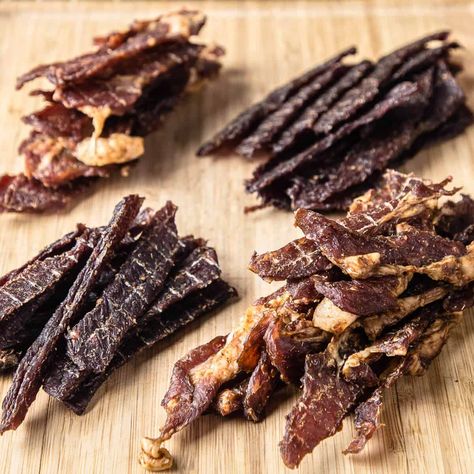 Authentic Thai jerky is often made with beef or pork and sun dried in a naturally humid climate. Both Thai beef jerky and Thai pork jerky are easy to make and dries quickly. If you've had this in the street food markets in Thailand, you know it's a delicious snack that differs from the American... Read More The post Thai Beef And Pork Jerky (Video) appeared first on PantsDownApronsOn. Jerkey Recipes, Basil Beef, Beef Jerky Recipe, Teriyaki Beef Jerky, Pork Jerky, Homemade Jerky, Jerky Recipe, Beef Jerky Recipes, Teriyaki Beef