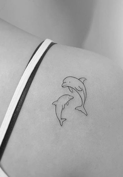 Tiny Dolphin Tattoos For Women, Tattoo Dolphin Small, Small Dolphin Tattoo Ideas, Fine Line Tattoo Dolphin, Cool Dolphin Tattoo, Dolphin Tattoo For Women Small, Matching Dolphin Tattoos, Minimal Dolphin Tattoo, 2 Dolphin Tattoo