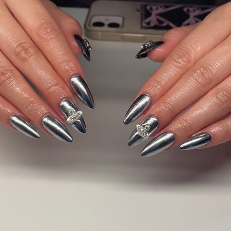 chrome addiction… chrome addiction… 🫢🙋🏼‍♀️ who’s with me? badass chrome dagger nails… to say i’m obsessed with this set is an understatement 😻 Service: GelX + Chrome and Charms Booking link is in my bio!! I have limited spots for August!! 🩷🩷 #yegnails #780nails #587nails #nailsofinstagram #nailart #cutenails #hardgelnails #buildergelnails #nailinspo #nails #trendynails #tiktoknails #pinterestnails #gel #yegartist #explorepage #ignails #nailsalon #magicnailsystem #gelx #softgelextension #... Xl Chrome Nails, Silver Chrome Drip Nails, Chrome Nails With Cross Charms, Silver Chrome Cross Nails, Silver 3d Chrome Nails, Hard Gel Nails, Builder Gel Nails, Magic Nails, Gel Extensions