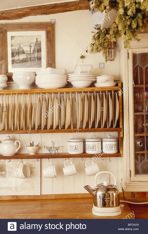 Download this stock image: Close-up of cream bowls and cups on wooden plate rack - BFCN19 from Alamy's library of millions of high resolution stock photos, illustrations and vectors. Plate Rack Cabinet, Plate Racks In Kitchen, Wooden Plate Rack, Cabinet Ikea, Primitive Kitchens, Kitchen Shelving, Dish Display, Cottage Decorating, Country Kitchens