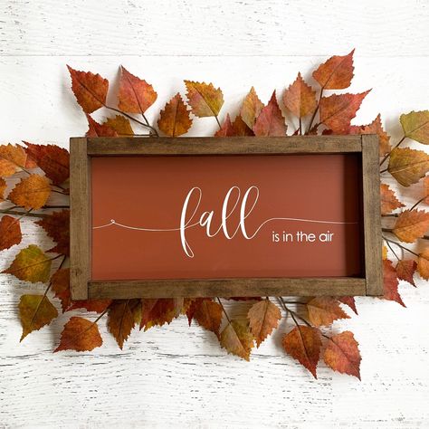 Fall air just has a unique scent, doesn't it? You can just smell the crispy leaves in the Autumn breeze. This Fall sign is perfect to hang on your wall or sit on a shelf. Details 7x13.5 Maroon background with white lettering. Dark walnut stained wood frame. Sawtooth hanger on back. Diy Autumn Signs, Rectangle Fall Signs, Autumn Wood Signs, Wood Wall Signs, Trending Fall Crafts 2023, Autumn Signs Wooden, Fall Wall Signs, Autumn Signs And Sayings, Autumn Signs Diy