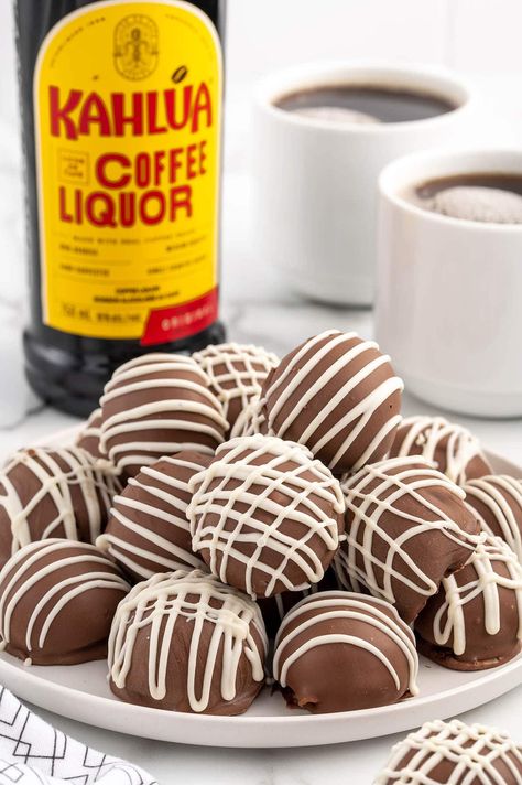 a couple of Kahlua Balls on a white plate with 2 mug of coffee and kahlua bottle on the background. Kahlua Cheesecake Balls, Kalua Cookies, Kalua Balls, Desserts With Kahlua, Kahlua Fudge Recipe, Recipes Using Kahlua, Kahlua Truffles Recipe, Kahlua Balls No Bake, Kahlua Cookie Recipes