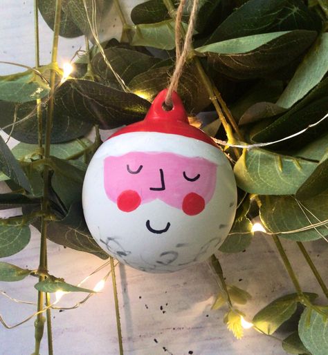 A hand painted Santa Claus ceramic bauble.  Hanging twine  Measures 6cm Painting Ornaments Kids, Bauble Painting Ideas Kids, Hand Painted Ceramic Christmas Baubles, Pottery Baubles, Ceramic Baubles Christmas, Painted Christmas Ornaments Bulbs, Bauble Painting Ideas, Bauble Decoration Ideas, Christmas Bauble Ideas