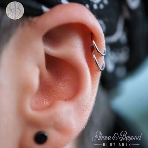 Double trouble 🤯 now THAT is a pretty pair of healed helixes. We did this double helix for Jo back in 2021, and they've been able to rock this crisp pair of rings for a while now, so of course we just has to get a picture! And if you look close you can spot an earlobe that we've been stretching with @gorillaglass 🖤🩶 📷: @50percentsnakes . . . #aboveandbeyondbodyarts #safepiercing #appmember #santabarbara #shoplocal #supportsmallbusiness #piercing #piercer #bodypiercing #bodyjewelry #finejewe... Double Helix Hoop Piercing, Double Helix Rings, Double Upper Helix Piercing, Double Helix Stud, Double Helix Piercing Hoop, Double Helix Piercings, Triple Helix Piercing, Anti Helix Piercing, Double Helix Piercing