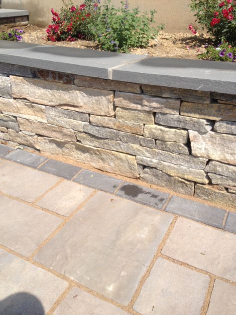 Paver Retaining Wall Raised Beds, Back Yard Brick Wall, Stone Half Wall Outside, Stone Wall Exterior Landscaping, Terraced Stone Retaining Wall, Half Circle Retaining Wall, Diy Backyard Retaining Wall, Bluestone Patio With Retaining Wall, Stacked Stone Retaining Wall Ideas