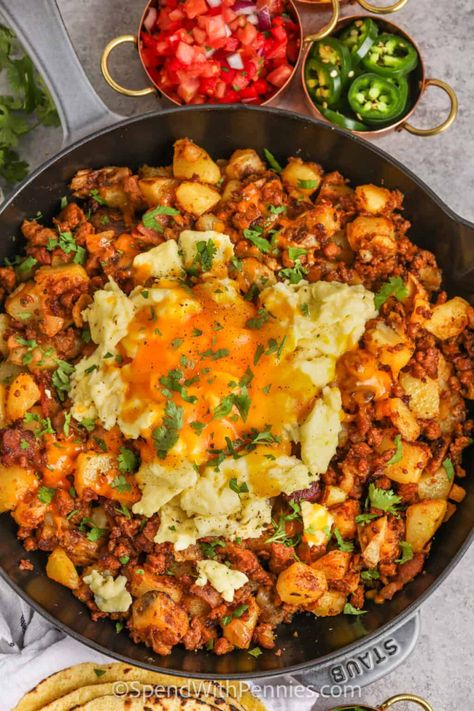 Start the day off right with this chorizo hash recipe. Spicy or sweet chorizo sausage is fried with bacon and then cooked with smooth and silky Yukon Gold Potatoes. Topped with eggs and cheese and then baked in the oven, this chorizo hash is so cheesy and filling. Make it a complete breakfast with a cup of coffee or tea!  #chorizohash #chorizobreakfast #beakfastchorizohash #spendwithpennies Breakfast Casserole Spicy, Breakfast Potato Skins, Best Mexican Breakfast Recipes, Papas And Chorizo, Chirozo Breakfast Recipes, Mexican Breakfast For A Crowd, Recipes With Chorizo Sausage Dinners, Chorizo And Beans, Chorizo Dinner Ideas