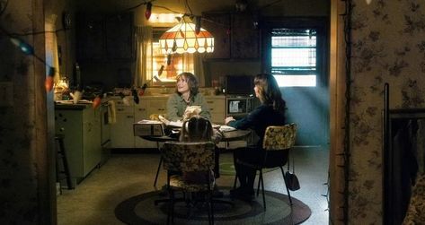 The Byers House, Stranger Things House, Byers House, 80s House, Rose In A Glass, Orange Lamps, Dinosaur Posters, Wooden Table And Chairs, Stranger Things Aesthetic