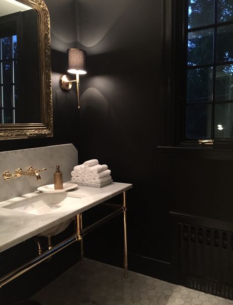 Powder room. Carrera marble hex floor, black walls and trim, unlacquered brass fittings, Palmer Industries sink legs, Currey and Co sconces. Sink Legs Bathroom, Black Powder Rooms, Wall Moulding Powder Room, Black Powder Bathroom, Powder Bath Black Countertop, Bathroom With Black Walls, Black Walls Bathroom, Black Bathroom Walls, Black Accent Wall Bathroom