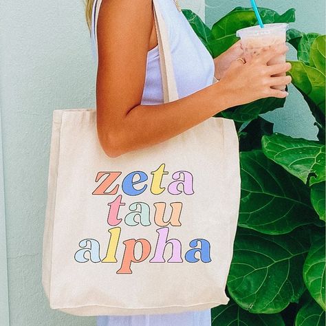 "Available For All 26 Panhellenic Sororities (PLEASE note that Alpha Delta Pi sorority only approves of traditional sorority colors to be used and will be altered accordingly for this item!) 6 oz., 100% cotton 23\" Self-fabric handles 10 1/2 handle drop Made of 100% Natural Cotton 10 1/2\" W x 16\" H" Sorority Tote Bags, Lambda Theta Alpha Latin Sorority, Sorority Graduation Gifts, Panhellenic Sororities, Sorority Graduation, Little Gifts Sorority, Sorority Cups, Alpha Delta Pi Sorority, Sorority Clothes