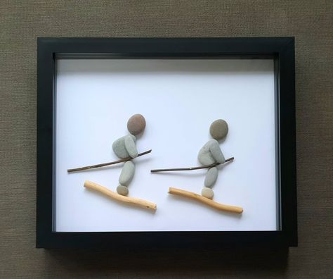 Personalised Skiing pebble art. Please include the wording you would like on your picture in the personalisation box provided. The stones and wood used may vary slightly but will be every bit as lovely. The frame size is 27.5 x 22.5 cm, the picture size is 25 x  20 cm. The depth is 3.5 cm. This can be stood freely on a shelf and is available in a white, grey or black acrylic frame. Please select frame colour required. PLEASE NOTE: I love to take photos of all the work I produce! I may use it on my website or social media pages when I believe it is ok to do so. (When it has been received or after the date of an event if I am aware of the date) Please do let me know if you would rather your pebble picture not be displayed. The estimated time given to process your order and dispatch (post) is Pebble Art Christmas, Rock Pictures, Stone Artwork, Stone Pictures Pebble Art, Beach Glass Crafts, Decorative Pebbles, Stone Wall Art, Pebble Art Family, Ski Gifts