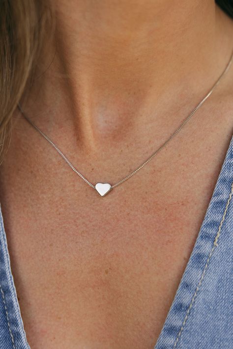 The most simple necklaces always make for the most memorable memories. Treat yourself or a loved one to our Simple Heart Necklace. This necklace features a silver heart, a dainty chain, secure clasp and a sterling sliver material so you know this necklace will last you past February! Length: 18" Simple Heart Necklace-Sterling Silver, boutique clothing, casual, the perfect necklace! Boutique Clothing Silver Necklaces For Women, Simple Silver Necklace Aesthetic, Silver Chains For Women Neck, Dainty Silver Jewelry Aesthetic, Heart Necklace Aesthetic, Silver Chains For Women, Basic Necklace, Simple Heart Necklace, Dainty Silver Necklace