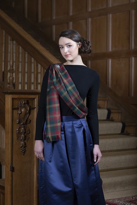 Show off your Scottish clan heritage and incorporate a tartan sash into your ladies’ highland dress outfit. If you are interested in how to style your sash traditionally or looking for inspiration for a more contemporary look, find out more in our guide. Traditional English Clothing, Tartan Aesthetic, Traditional Scottish Dress, Scottish Outfit, Tartan Sash, English Clothes, Scottish Dress, Scottish Clothing, Scottish Style