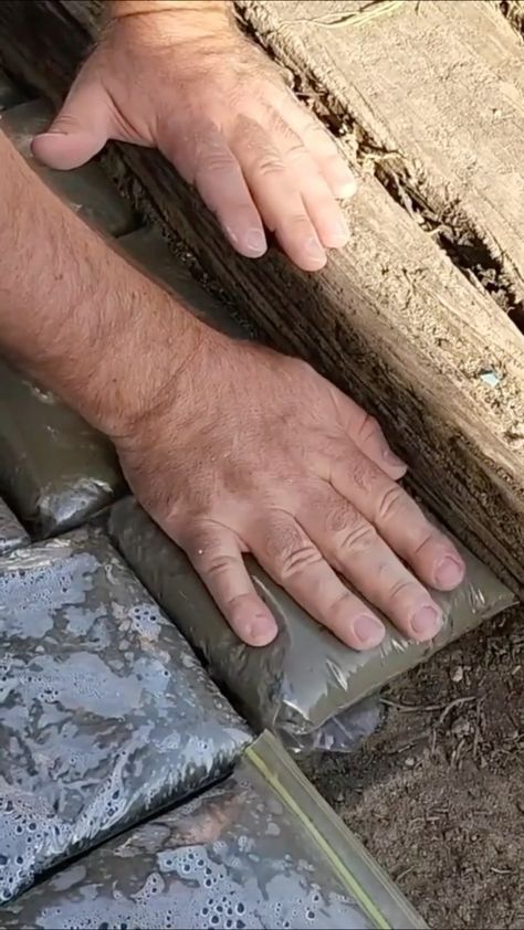 hometalk on Instagram: Lay ziploc bags full of cement in your backyard...😱 @goodlyearth⁠ .⁠ .⁠ @ziploc⁠ .⁠ .⁠ #DIY #HowTo #Garage #Makeover #DIYProject… Cement Bag Wall, Cement Pavers, Diy Path, Concrete Bags, Concrete Walkway, Concrete Pad, Landscape Stone, Garage Makeover, Concrete Pavers