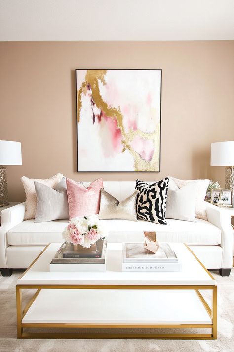 Pink and gold living room ideas are a beautiful combination for creating a sophisticated and elegant space.  Explore plush pink sofas, gold coffee tables, and metallic throw pillows.  Discover pink accent walls, gold-framed artwork, and rose gold lighting fixtures.  Find inspiration for pink and gold area rugs, velvet curtains, and gilded decorative objects to complete your luxurious living room. Living Room With Pink Sofa, Gold Interior Design Living Room, Pink Gold Living Room, Bohemian Glam Living Room, Pink And Gold Living Room, Rose Gold Lighting, Glamorous Living Room Decor, Gold Living Room Ideas, Gold Coffee Tables