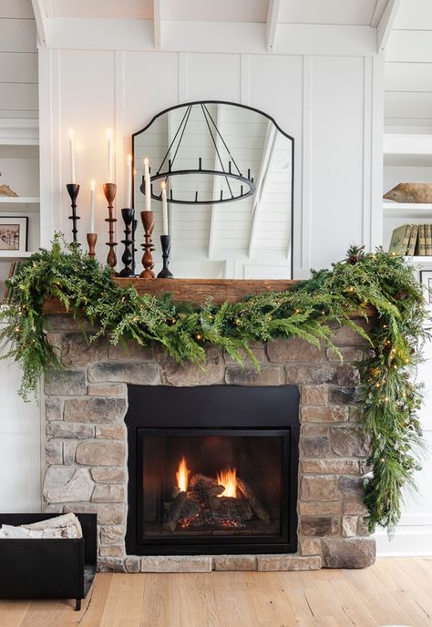 Rock Fireplace Christmas Decor, Garlin On Mantel, Asymmetrical Fireplace Garland, Diy Fireplace Christmas Garland, Classic Christmas Mantle Decor, Black Mantle Christmas Decor, How To Hang Garland On Fireplace, How To Decorate Mantle For Christmas, Christmas Decor On Fireplace