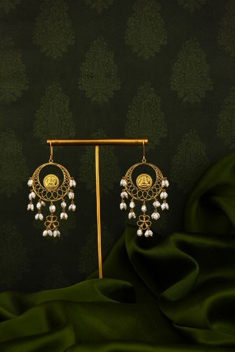 Crafted in pure 22K gold, the enchanting chandbali earrings are designed with the finesse of gold filigree work that beautifully enhances the bali, while it is fringed with tiny pearls hanging from the crescent of the moon. The signature Lakshmi Kasu coin reflects the touch of divinity adding a deep sense of emotional value to the piece. #jewellery#handmade#gold#accessories#love#jewellerylover#jewelleryaddict#jewellerydesign#jewelleryoftheday#jewellerylovers#jewellerycollection#jewellerytrend Chandbali Earrings, Jewellery Handmade, Gold Filigree, Gold Accessories, Handmade Gold, 22k Gold, Gold Jewellery, Crescent, The Moon