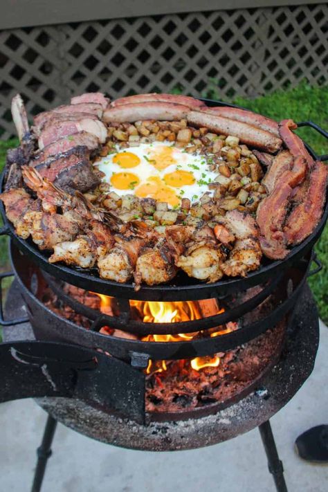 Breakfast Skillet being cooked over the fire Ways To Cook Steak, Over The Fire Cooking, Bacon Wrapped Shrimp, Camping Breakfast, Steak And Shrimp, Breakfast Skillet, Sliced Steak, Fire Food, Cast Iron Recipes