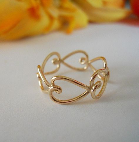 "Berkley street artist meets sassy career girl. This ring is flirty, sassy and beautiful. And don't think it has to be a gift from your husband/boyfriend. Nothing says you can't buy it for yourself, or a friend. One Valentines Day I gave all my girlfriends one. I make this ring from from 14K Gold Filled wire. Little hearts are individually made from 18ga wire and soldered together to create one complete and unique ring. DIMENSIONS: The width is between 7mm-9mm, wider with larger sizes. --------- Diy Wire Jewelry Rings, Wire Jewelry Patterns, Wire Jewelry Rings, Wire Jewelery, Wire Jewelry Designs, Custom Jewelry Ideas, Handmade Jewelry Tutorials, Diy Wire Jewelry, Anthropologie Jewelry