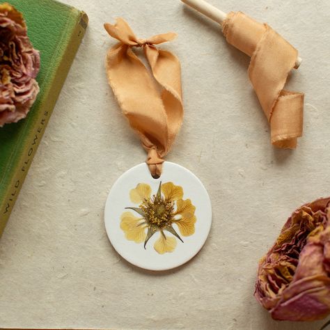 Pressed Flower Ornaments I’m delighted to let you know that my latest Collection is now live on my webshop. Beautiful homegrown and traditionally pressed flowers on handmade white clay discs, finished with stunning hand-dyed silk ribbon. There are two sizes to choose from (small: 5.5cm diameter, and large 7.5cm diameter). Perfect for festive decorations or for displaying all year round. Each one is completely unique and made with love. I hope you enjoy them. 🤍 #collectionlaunch #flowersar... Dried Flower Crafts, Crafts Clay, Hand Dyed Silk Ribbon, Flower Ornaments, Dyed Silk, Hand Dyed Silk, Pressed Flower, White Clay, Art Therapy