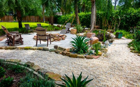 Whether your prefer grass, rocks, sand, or a combination of all three for your backyard's landscaping, our team can make it happen. This backyard uses sand to create a tropical backyard paradise, complete with lounge chairs and a fire pit. Sand Backyard, Landscaping Sand, Beach Theme Backyard, Beach Fire Pit, Sand Patio, Beach Backyard, Tropical Backyard, Cheap Backyard, Backyard Beach