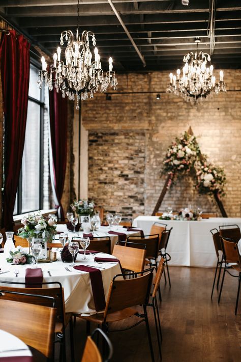 Elegant dining room setup with chandeliers, exposed brick wall, and floral decorations. Micro Event Space, Small Event Space Design, Graduation Party Venues, Small Event Space, Event Space Design, Event Venue Spaces, Private Event Space, Date Today, Event Stand