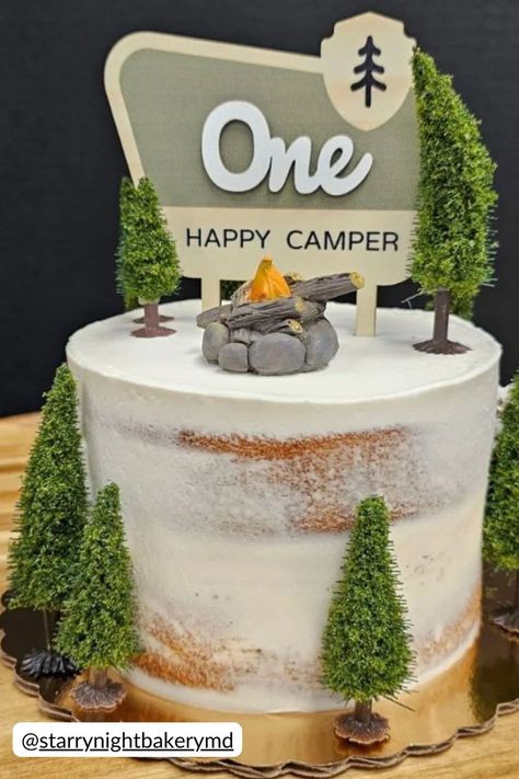 One Happy Camper birthday cake featuring a minimalist design with a faux campfire and miniature trees. The cake is topped with a One Happy Camper sign, perfect for a camping themed first birthday party. Camper Smash Cake, Happy Camper Smash Cake, One Happy Camper Smash Cake, Birthday Creative Ideas, Camping Theme Cakes, One Happy Camper First Birthday, Camper Cakes, Happy Camper Birthday Party, Camping Theme Birthday Party