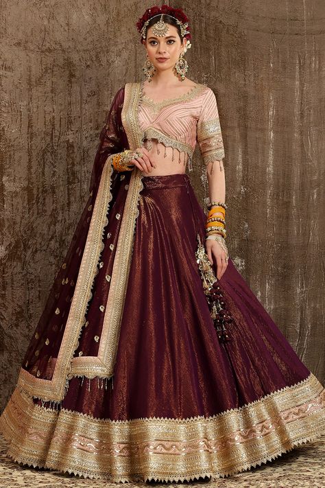 Featuring a dark purple lehenga in cotton shimmer chanderi base with fine gota and dori machine embroidery. It is paired with a contrasting baby pink embroidered blouse in silk chanderi base and a net dupatta.  FIT: Fitted at bust and waist COMPOSITION: Cotton shimmer chanderi, Silk chanderi, Net. CARE: Dry clean only. Chanderi Lehenga, Baby Pink Blouse, Purple Lehenga, Orange Lehenga, Wedding Lehenga Designs, Lehenga Designs Simple, Maroon Blouse, Red Lehenga, Indian Wedding Wear