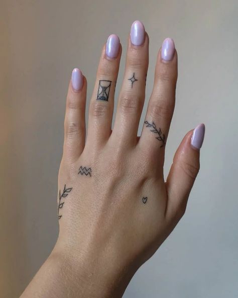 14 Best Aquarius Tattoos Full of Meaning - HowLifeStyles Finger Tattoos Aquarius, Aquarius Finger Tattoos For Women, Aquarius Tattoo Finger, Creative Finger Tattoos, Aquarius Hand Tattoo, Lebanon Tattoo Ideas, Meaning Full Art, Aquarius Minimalist Tattoo, Small Aquarius Tattoo