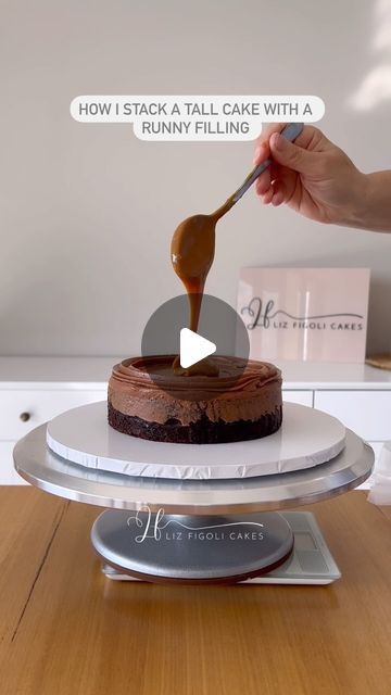 LIZ FIGOLI CAKES on Instagram: "How I stack a tall cake with a runny and slippery filling 👇🏼

1. I add a layer of icing and pipe an icing dam with a piping tip, then seal the bottom to close any gaps so that no caramel can spill out. 

2. This cake is 6” x 5 layers, I use a board and dowels for any cakes taller than 4 layers, I add 4 timber dowels and a perforated board after 3 layers.

3. I crumb coat the bottom 3 layers and chill the cake for 5 mins to prevent the layers from slipping around then continue adding layer 4 and 5. 

4. I add 1 final dowel through the center of the whole cake.

5. I fill in any gaps and crumb coat the cake in chocolate then I chill the cake in the fridge, and give it another thin crumb coat in white buttercream. 

If you have any questions let me know in th Waffle Cake Ideas, 3 Layer Wedding Cake, Cake Dowels, White Buttercream, Waffle Cake, Tall Cakes, Baking Tutorial, Piping Tips, Wedding Cakes With Cupcakes