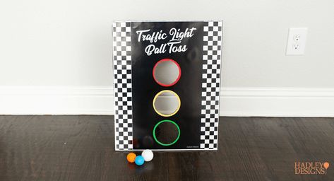 There's no need to reinvent the wheel. Take a new look at some classic games to make perfect DIY games and activities for your kid’s race car birthday. Instead of pin the tail on the donkey, there’s a printable pin the wheel on the car. Instead of regular-old ball toss, there’s a traffic light ball toss. There’s also a huge, race car track printable to color and play on. These are fun activities for any NASCAR, Formula 1, Hot Wheels, or Cars themed birthday party. Race Car Party Games Activities, Race Car Birthday Game Ideas, Car Games For Birthday Party, Pixar Cars Birthday Party Activities, Traffic Theme Party, Games For Race Car Party, Racecar Party Activities, Race Car Diy Decorations, Motocross Birthday Party Games