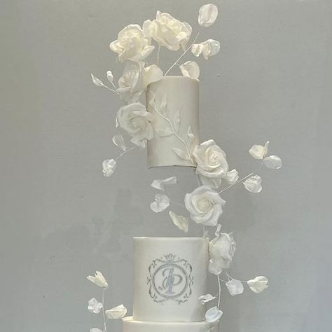 Claire Davey on Instagram: "A white on white floating design for P & J. Their wedding cake was adorned with sugar roses, wafer paper leaves and vines and the most perfect bespoke monogram detail. A truly personal cake for my wonderful couple Venue @manorbythelake Floating stand @prop.options The stage cake stand @prop.options Custom monogram stencil @amelieskitchenstencils #manorbythelake #cheltenhamwedding #weddingcakesideas #whiteweddingcake #tallweddingcakes #floatingcake #propoptions Floating Cake Wedding, Tall Wedding Cakes, Monogram Stencil, Paper Leaves, Engagement Cakes, White Wedding Cake, Wafer Paper, White On White, Custom Monogram