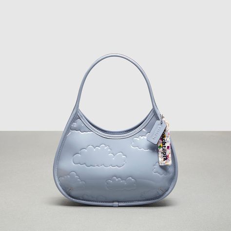 Find COACHTOPIA Ergo Bag In Crinkle Patent Leather With Print on Editorialist. The Coachtopia Ergo shoulder bag is a modern take on a classic 90s design, crafted with at least 40% recycled or repurposed materials. This bag is made from leather scraps and other materials that would have otherwise gone to landfill. It features an embossed cloud print and is made according to the brand's Made Circular principles, promoting sustainability and responsible manufacturing. 90s Design, Cloud Print, Leather Scraps, Embossed Leather, Eye Candy, Patent Leather, Shoulder Bag, Luxury Fashion, Leather