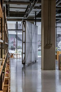 LUO Studio uses rotating walls to create flexible Mumokuteki bookshop Chinese Garden Design, Exposed Ceilings, Moving Walls, Metal Bookcase, Flexible Space, Modular Walls, Glass Walls, Chinese Architecture, Beijing China