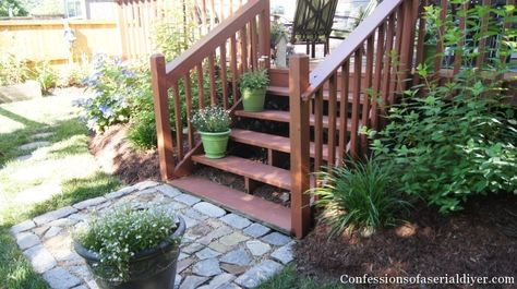 Not a bad idea for the landing by the back deck stairs Landing Steps To Patio, Stone Landing Stairs Outdoor, Deck Stair Landing Ideas, Bottom Of Deck Stairs Landing, Pavers At Bottom Of Deck Stairs, Landscaping Around Deck Stairs, Patio Landing Ideas, Deck Landing Ideas, Back Deck Stairs