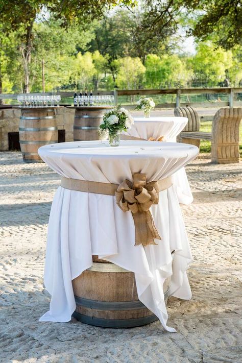 Wine-Barrel Cocktail Table With Burlap Bow Wine Barrel Dessert Table, Wedding Wine Barrel Decor, Outdoor Wine Table, Wine Barrel Wedding, French Themed Parties, Wine Table, Burlap Bows, Wine Barrel, Cocktail Tables