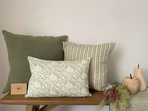 Beautiful natural & green modern farmhouse style linen cushion covers available as a bundle including: 1 x NINA 50cmx50cm 1 x EVELYNN 45cmx45cm 1 x MARGAUX 30cmx45cm All of these cushion covers are backed in Laura Ashley Austen Natural fabric with invisible zips along the bottom edge for ease of removal. These cushion covers are spot or dry clean only and should be ironed on medium heat. DELIVERY OPTIONS: If you wish to purchase the cushion covers only, select standard delivery at checkout. If y Grey Sofa Green Cushion, Cushions For Dark Green Sofa, Beige And Green Home Decor, Sage Cushions Living Rooms, Green And Pink Cushions Living Room, Modern Farmhouse Cushions, Green Cushion Combinations, Sage Green Cushions Bedroom, Dark Grey Sofa Green Cushions