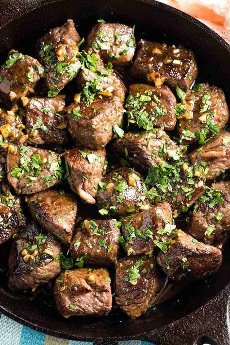 This easy Garlic Butter Steak Bites recipe sears chunks of beef to tender perfection and serves them with a rich bloody mary-inspired red wine sauce for dipping. Ready in less than fifteen minutes, you can enjoy these succulent bites as an appetizer or round them out into a quick dinner. | how to make garlic butter steak bites | garlic butter steak bites recipes | homemade steak bites | steak bites in cast iron skillet | steak bites with garlic butter cast iron | steak bites dinner ideas Steak Bites Recipes, Butter Steak Bites Recipe, Steak Bites With Garlic Butter, Cajun Butter Steak, Beef Rib Steak, Garlic Steak Bites, Boneless Beef Ribs, Easy Garlic Butter, Gluten Free Recipes Appetizers