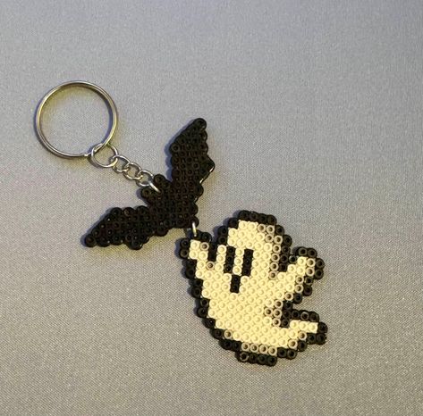 [Fall/Halloween Collection] BOO! Did I scare you? Spooky season is upon us! We decorate our houses for Halloween, but why not our keyrings?! This cute perler Ghost and Bat keychain would be the perfect addition to any keyring during this Spooky Season!  *Handmade to order. **Exchanges are available within 30 days, should the keychain break. Perler Keychain, Cute Perler, Halloween Perler, Bat Keychain, Melty Bead Designs, Melt Beads Patterns, Pearl Beads Pattern, Easy Perler Beads Ideas, Bat Halloween