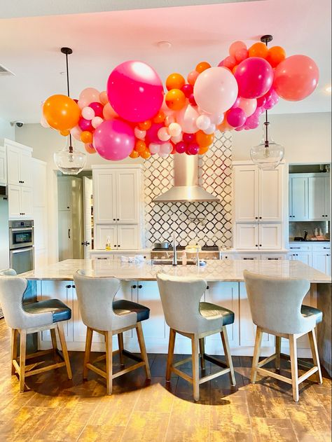 Balloon Garland Above Kitchen Island, Balloons On Chandelier, Deck Balloon Decor, Kitchen Island Balloon Garland, Balloon Arch Over Kitchen Island, Balloon Garland From Ceiling, Balloon Garland Over Kitchen Island, Kitchen Balloon Decoration, Stairwell Balloon Garland