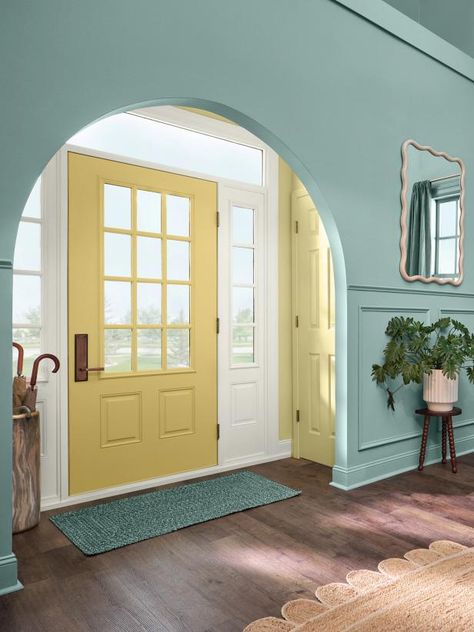 This year's collection isn't all about cool tones though. Warm shades like this golden yellow, Sequin, add a pop of sunny radiance. Surrounded by the muted green-blue arch, this front door shines extra bright. The sidelights around the door are painted with another staple in the palette: Snowbound. Green House Door Color Ideas, Arched Entryway, Arch Entryway, Two Tone Walls, Exterior Color Palette, Blue Green Paints, Door Paint, Yellow Doors, Favorite Paint Colors