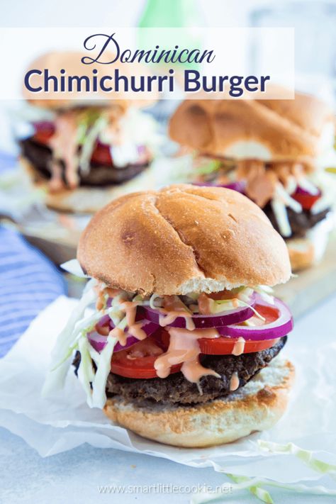 Dominican Chimichurri Burger is traditional Dominican street food. The burger patties are made with ground beef and seasoned with Dominican flavors. This flavorful Dominican burger is topped with tomatoes, slightly pickled red onions, shredded cabbage, and a big spoonful of mayo-ketchup sauce. #smartlittlecookie #DominicanRecipes #LatinRecipes #Burger #Recipe Chimichurri Burger, Dominican Dishes, Dominicano Recipes, Shredded Cabbage, Burger Patties, Dominican Food, Rican Food, Cooked Cabbage, Chimichurri Sauce