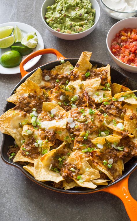 Cast Iron Loaded Beef Nachos. For nachos that could hold their hot-out-of-the-oven appeal until the very last chip is snagged, we moved this happy-hour favorite to the cast-iron skillet. While it may not be traditional, it turned out to be the perfect vessel for nachos; not only did it mean we could use fewer dishes, but cast iron also holds onto heat, so the nachos stay warmer longer after you take them out of the oven. Ground Beef Dip, Pitboss Recipes, Recipe For Nachos, Beef Dip Recipe, Taco Bread, Football Dishes, Skillet Nachos, Eat Time, Beef Nachos