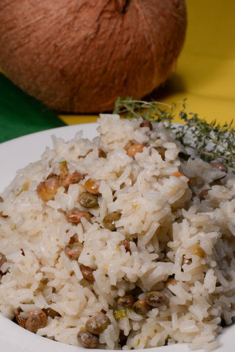 Jamaican coconut rice is a true staple food.  The addition of coconut milk while simmering the rice makes for a true tropical delight.  This rice can be made with either red beans or pigeon peas to be authentic.  It is served as side dish with everything, fish, chicken, goat etc.  I served ... Jamaican Coconut Rice, Jamaica Food, Carribean Food, Jamaican Cuisine, Jamaican Dishes, Pigeon Peas, Island Food, Coconut Rice, Jamaican Recipes