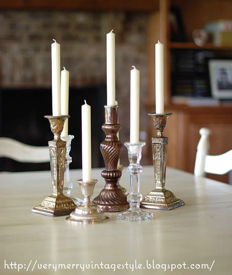 Another obsession of mine....candlesticks. Who ever said you can't mix metals, media, and the like?  Baloney.  Amazing and tasteful eclectic mix of candlesticks. Crystal Candlesticks Wedding, Candlestick Display, Antique Decorations, Backyard Decorations, Stick Decor, Quick Wedding, Here There And Everywhere, Candlestick Centerpiece, Candle Stick Decor